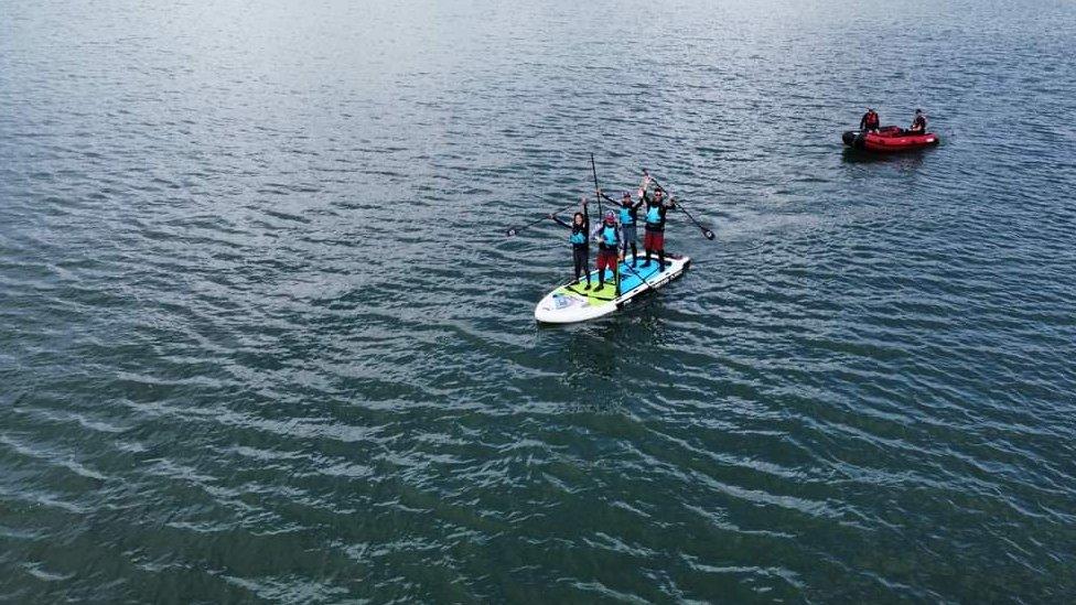 Jess Ashley, Oli Jordan, Andy Large and Matt Payne on the giant paddleboard