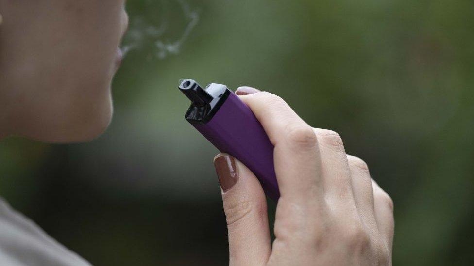 Woman smoking disposable vape