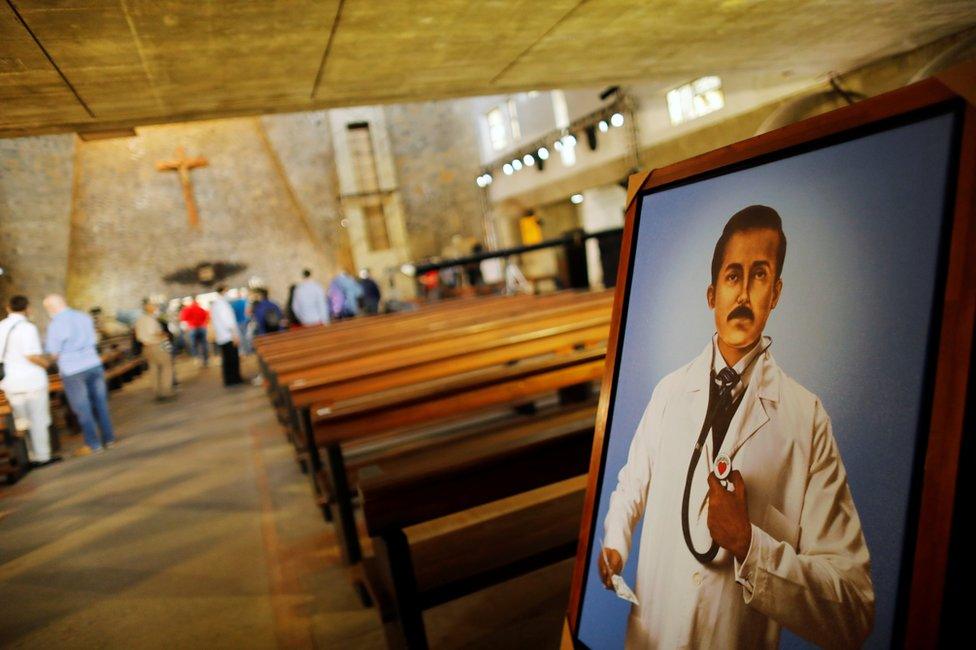 A painting of Venezuelan doctor Jose Gregorio Hernandez is seen by the main door in the church of Colegio La Salle, during preparations for the April 30 beatification ceremony of Hernandez, In Caracas