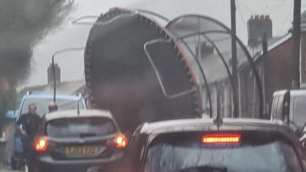 Wind blows giant trampoline into road