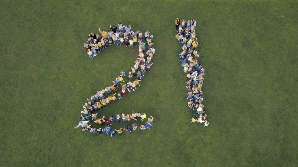 School creating a 21 shape on school playing fields.