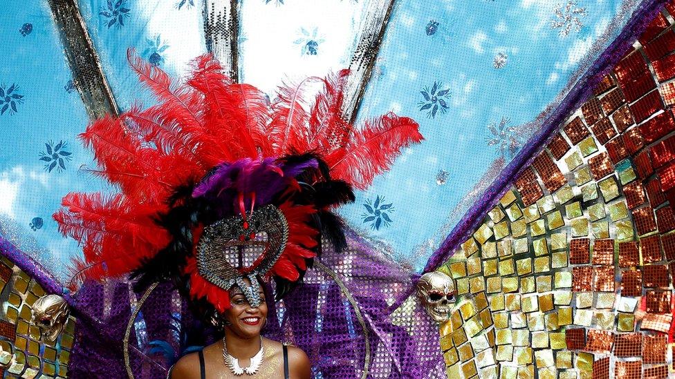 Revellers take part in the Notting Hill Carnival in London