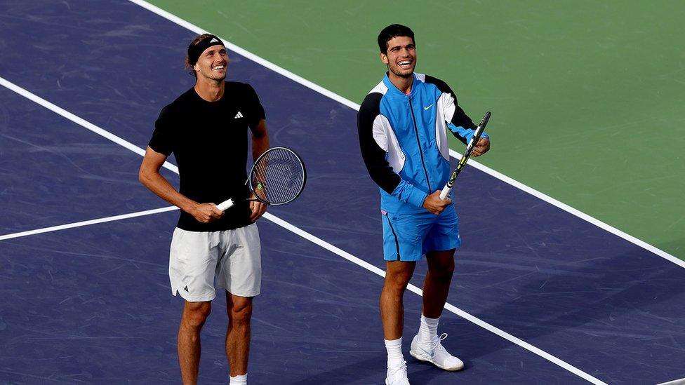 Alexander Zverev of Germany and Carlos Alcaraz of Spain watch as bees are removed from the stadium during the BNP Paribas Open at Indian Wells Tennis Garden
