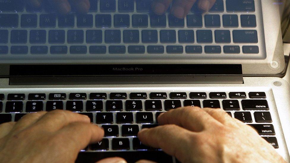 In this Feb. 27, 2013, file photo, hands type on a computer keyboard in Los Angeles.