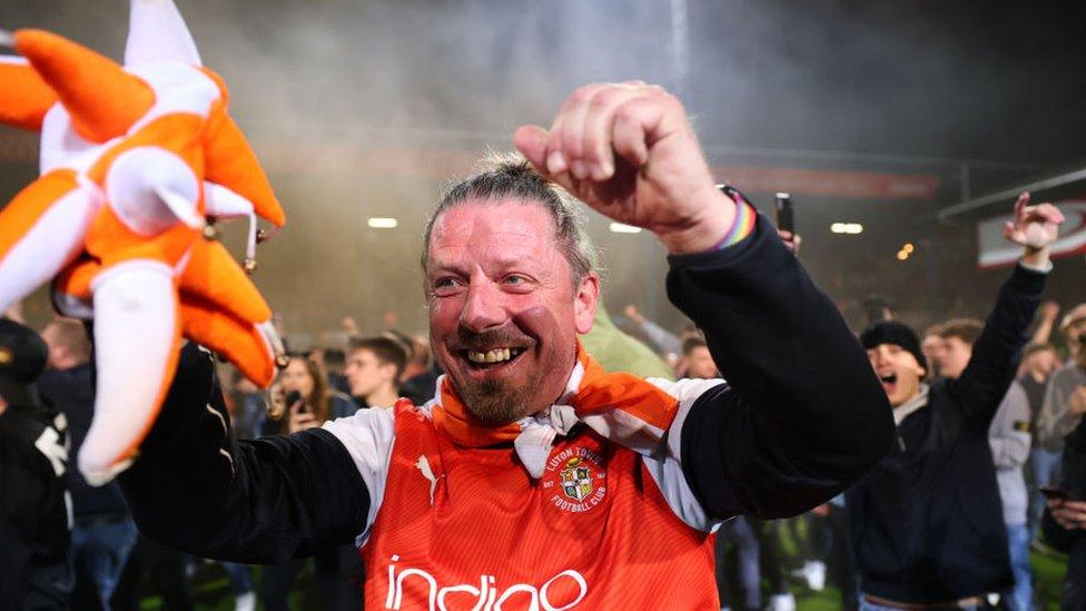 A Luton fan celebrating at Kenilworth Road, Luton