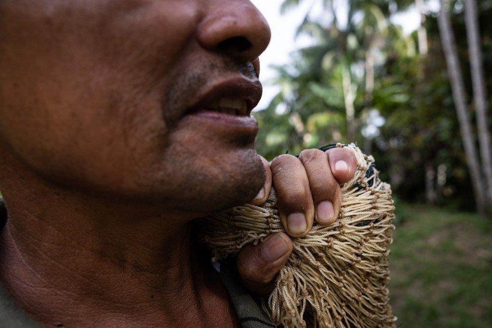 Fisherman Orlando Rufino holds a fishing net