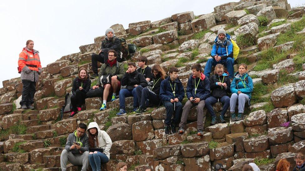 Tourists gathered on the volcanic stones to get a sneak peek of the royals