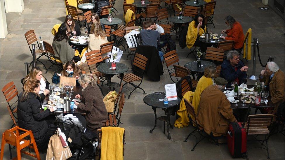 People dining at tables outdoors