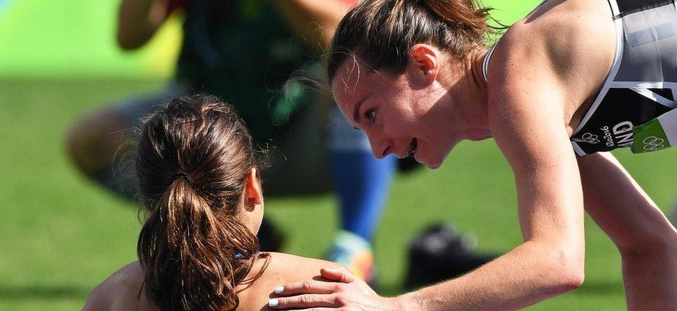 Abbey D"Agostino (L) of the USA is helped up by Nikki Hamblin (R) of New Zealand after both fell during the women"s 5000m heats of the Rio 2016 Olympic Games Athletics, Track and Field events at the Olympic Stadium