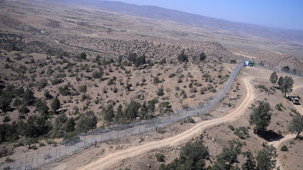 Pakistani soldiers patrol next to a newly fenced border fencing along with Afghan's Paktika province border in Angoor Adda in Pakistan's South Waziristan tribal agency