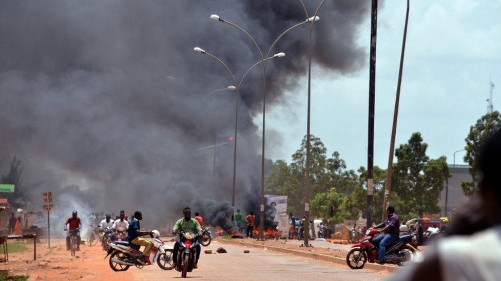 Residents burn tires along a street in Ouagadougou on September 17, 2015