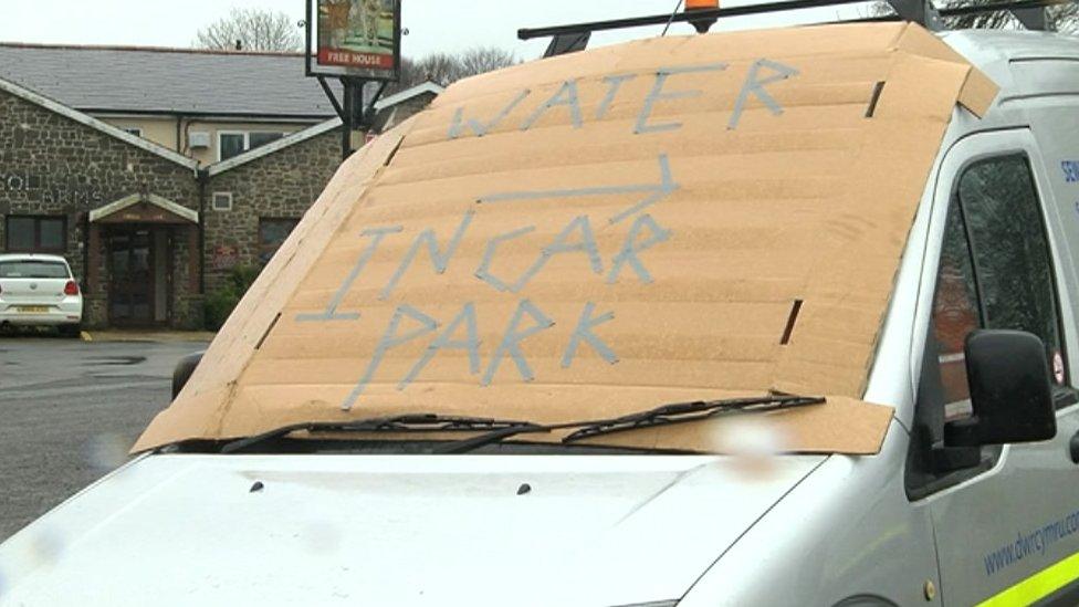 'Water in car park' sign