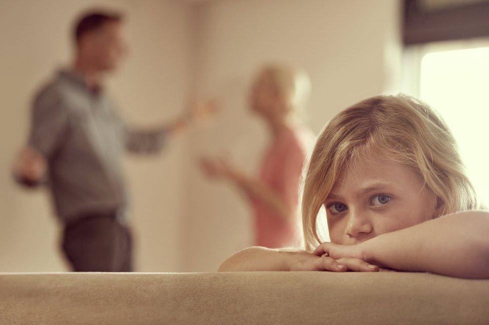 A little girl with arguing parents