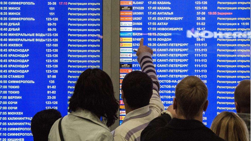 Russians at Domodedovo airport in Moscow look at information board (file pic Nov 2015)