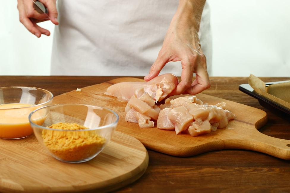 Person preparing chicken