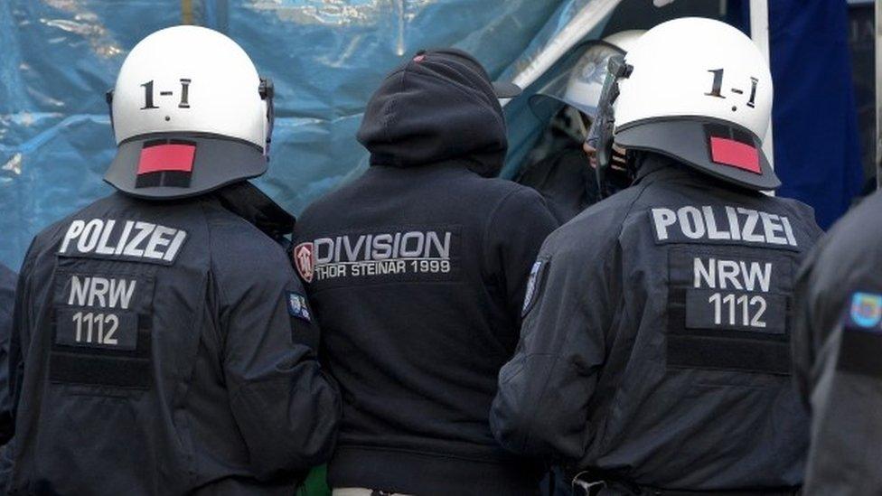 Police control a protester against the New Year's Eve sex attacks in Cologne on Saturday (09 January 2016)