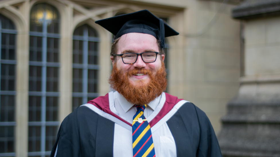 Matt Guy wearing graduation robes