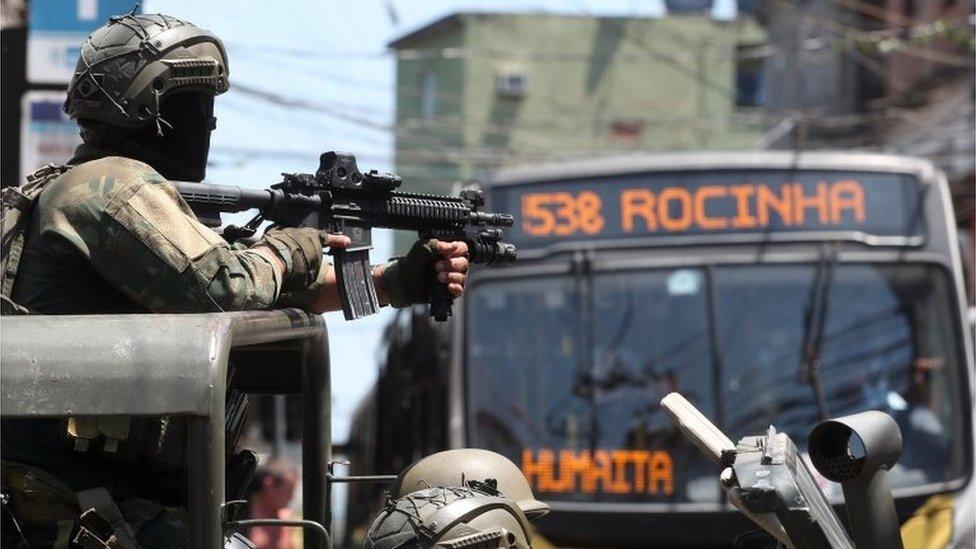 Soldiers of the Brazilian Army patrol a street of the favela Rocinha, in Rio de Janeiro, Brazil, 10 October 2017.