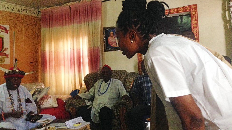 Oge Maduagwu bowing to greet a traditional ruler, during one of her advocacy meetings