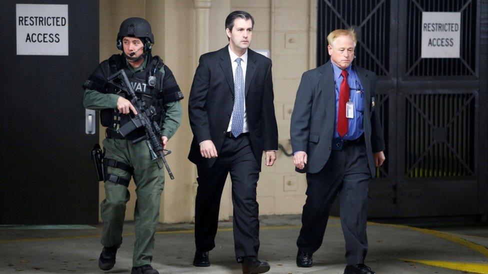 Security outside the courthouse escort Slager (centre) to trial