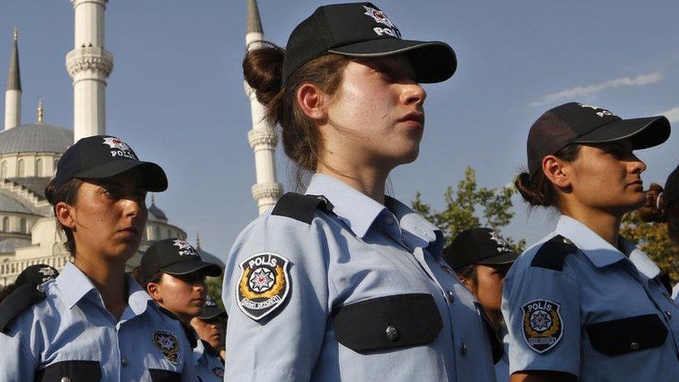 Rows of policewomen in uniform including baseball caps, at a mass funeral in Ankara for a policeman who died in Turkey's failed coup. 18 July 2016.