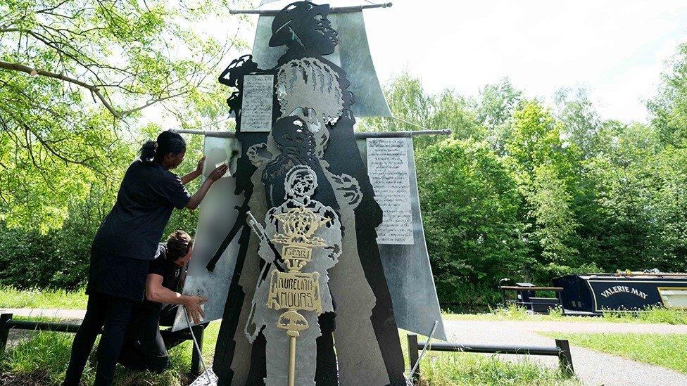 The statue being cleaned