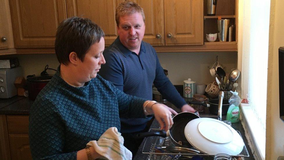 Anna Maven and her husband Paul washing up