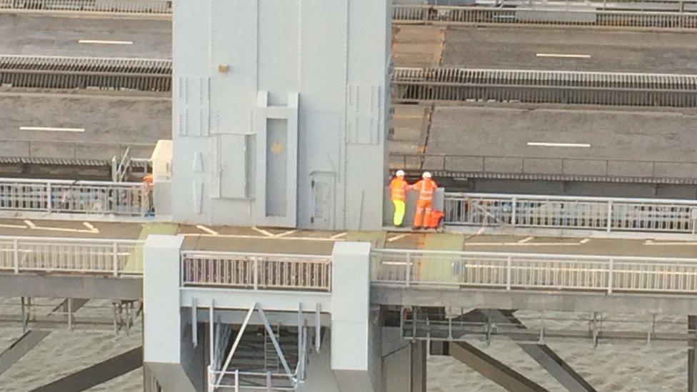 Workmen on bridge