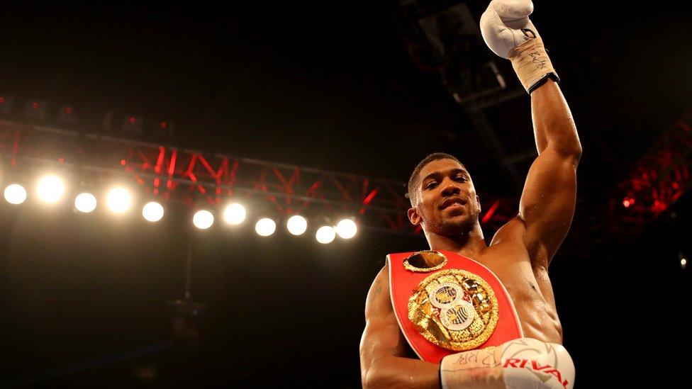 Anthony Joshua raises his arm aloft after a win