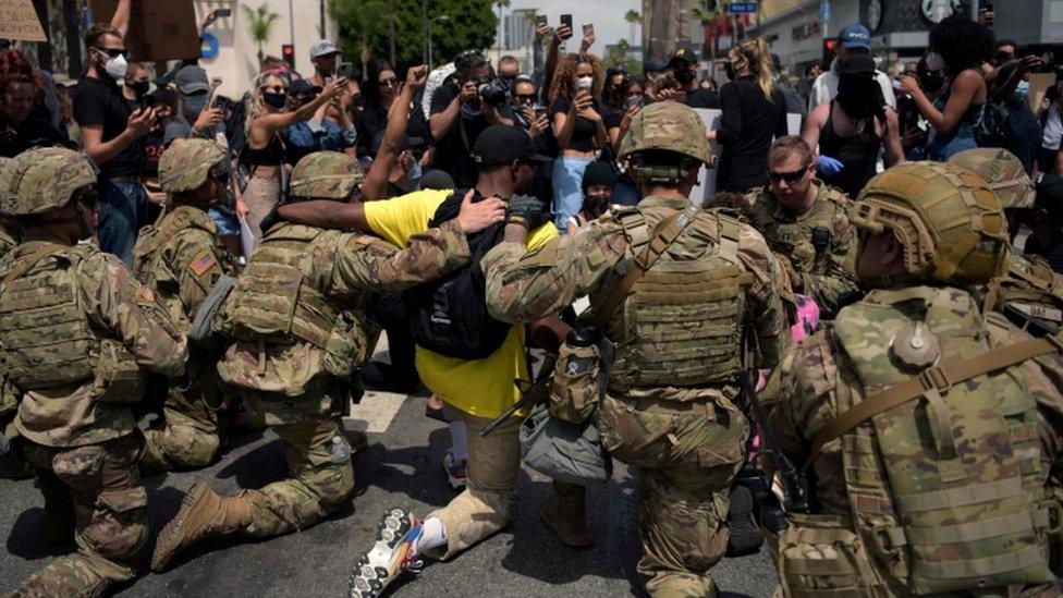 In Los Angeles large numbers of protesters made their point peacefully and avoided clashes with the National Guard officers monitoring the situation. These National Guardsmen also knelt with protestors to try to show they weren't on opposite sides.