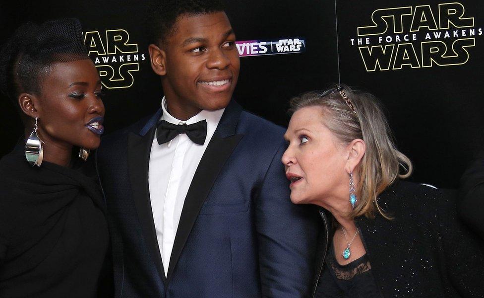 Lupita Nyongo (left) with John Boyega (centre) and Carrie Fisher (right)