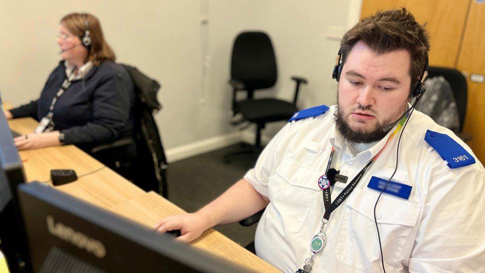 Control room operator, Dan, at work at Bedfordshire Police headquarters