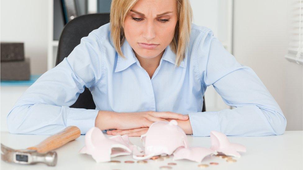 Woman with smashed piggy bank