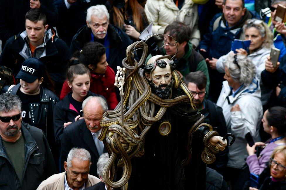 A statue of Saint Domenico covered with live snakes is carried by faithfuls during an annual procession in the streets of Cocullo