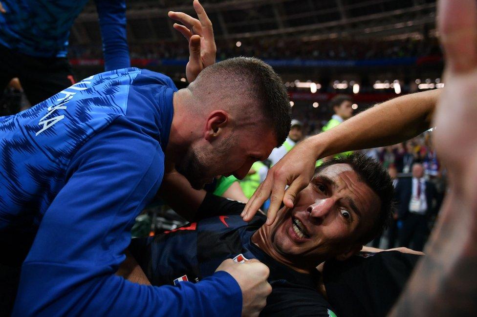 Croatia's forward Mario Mandzukic (C) celebrates with teammates after scoring his team's second goal during the Russia 2018 World Cup semi-final football match