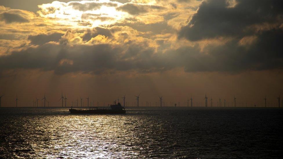 Cargo ship sales past wind farm