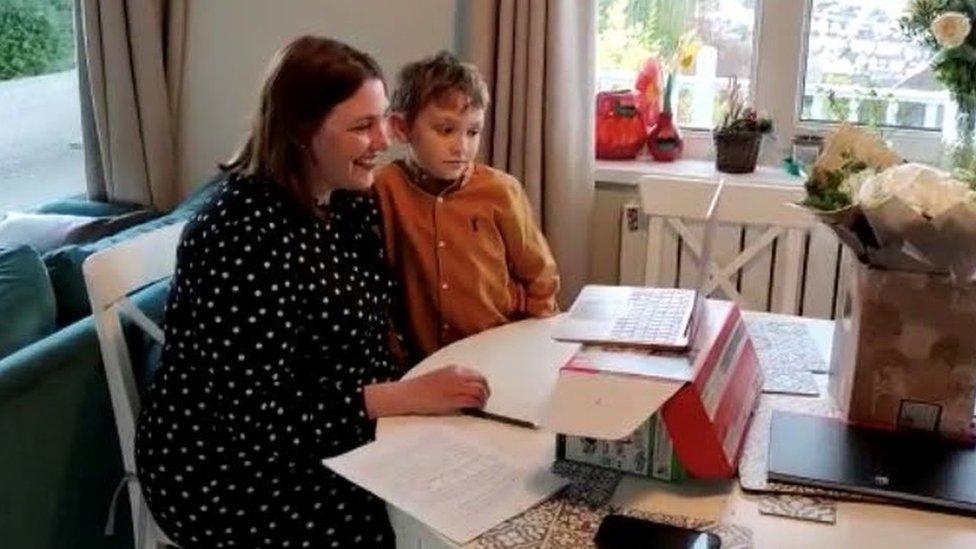 Heledd Fychan being sworn in from home with her son alongside her