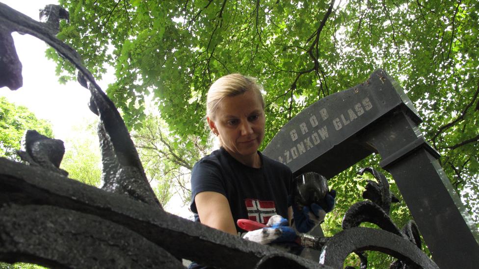 Volunteer Monika Siwczyk at work restoring graves in the Okopowa cemetery