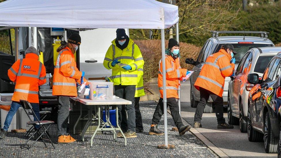 Testing staff prepare and hand out kits to motorists attending a surge testing centre at the Science Park, Emersons Green, in Bristol, Gloucestershire.