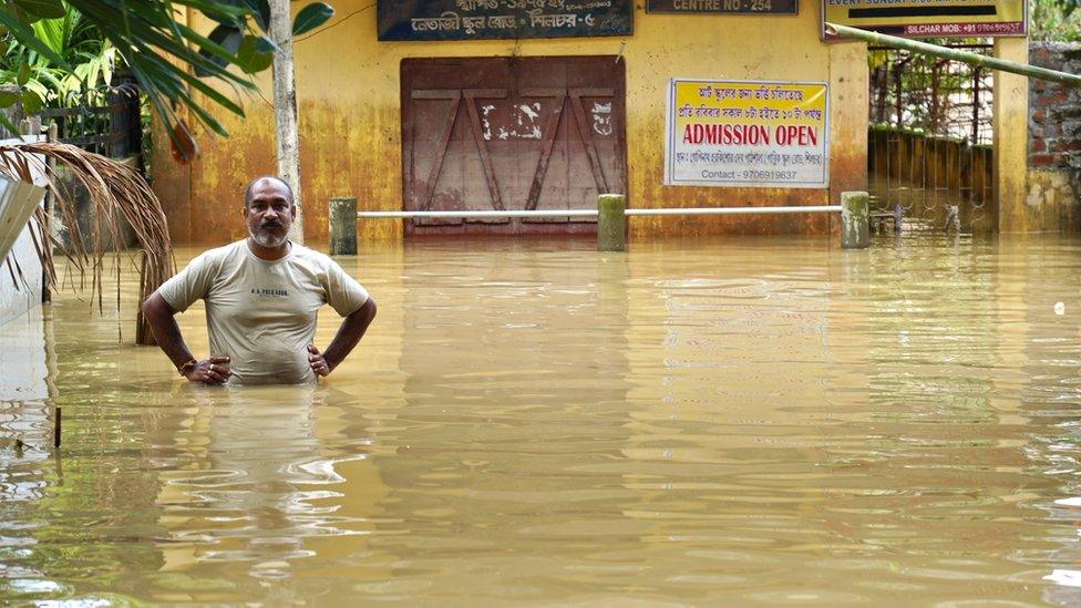 Man seen outside makeshift shelter in Assam