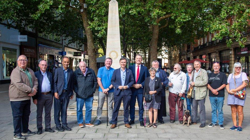 Veterans and councillors next to war memorial