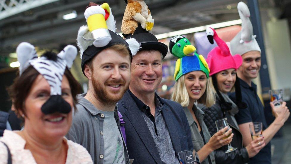 Friends pose during the traditional hat day during the CAMRA Great British Beer Festival at Olympia in London