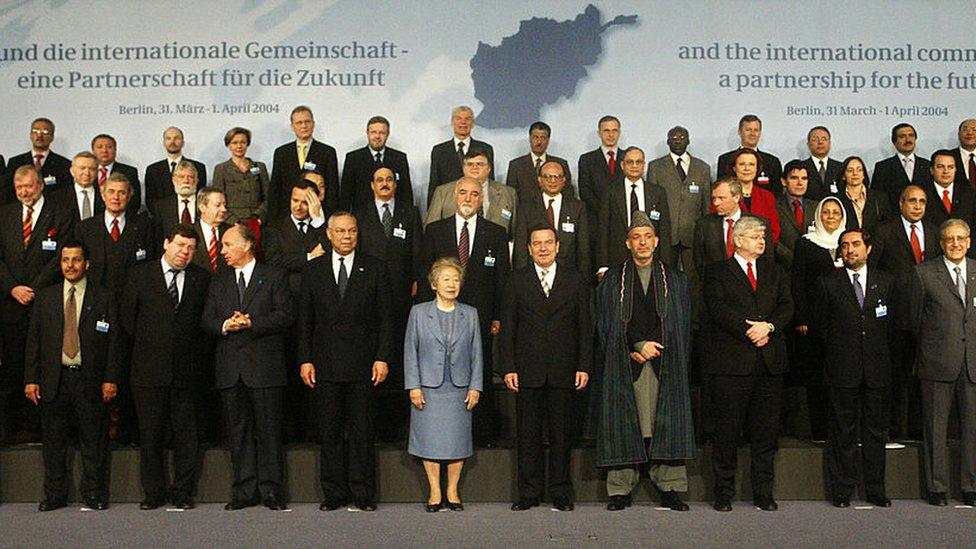 Representatives from more than 60 countries pose for the family picture at the opening of the international conference in Berlin