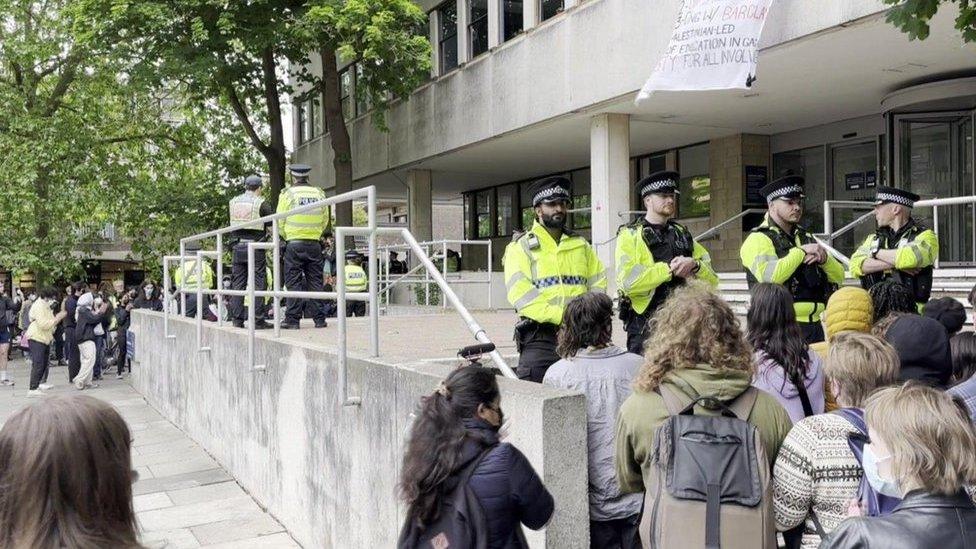 Police outside an Oxford university building, stopping people from entering