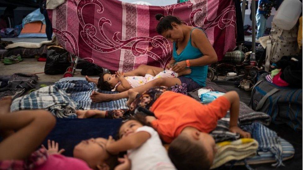 Frances, a migrant woman from Honduras taking refuge in a shelter with a caravan from Central America trying to reach the United States, dresses her one year old daughter Sujey in Tijuana, Mexico November 20, 2018.