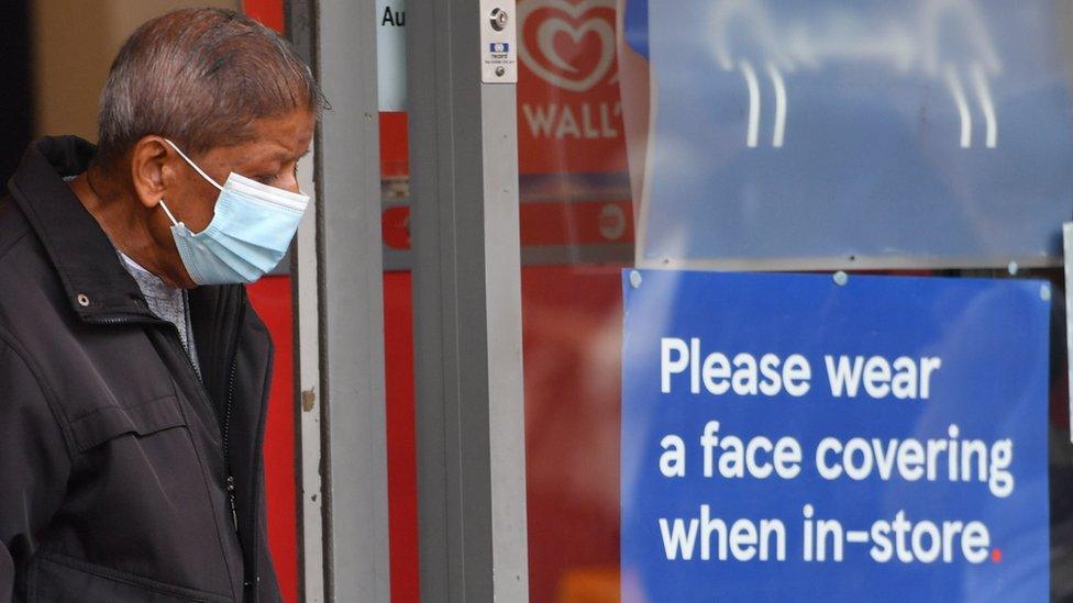 Man in mask at Tesco shop