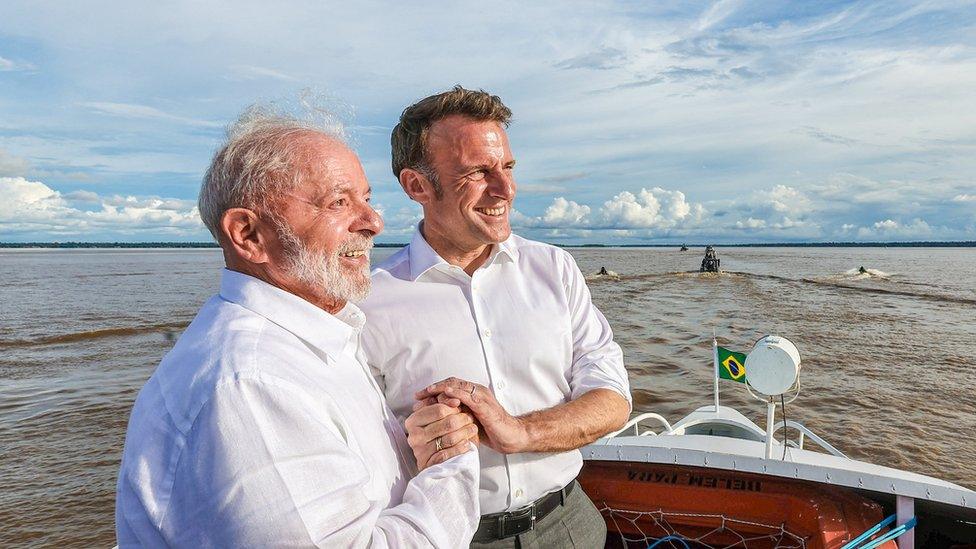 Brazil's President Luiz Inacio Lula da Silva shakes hands with France's President Emmanuel Macron