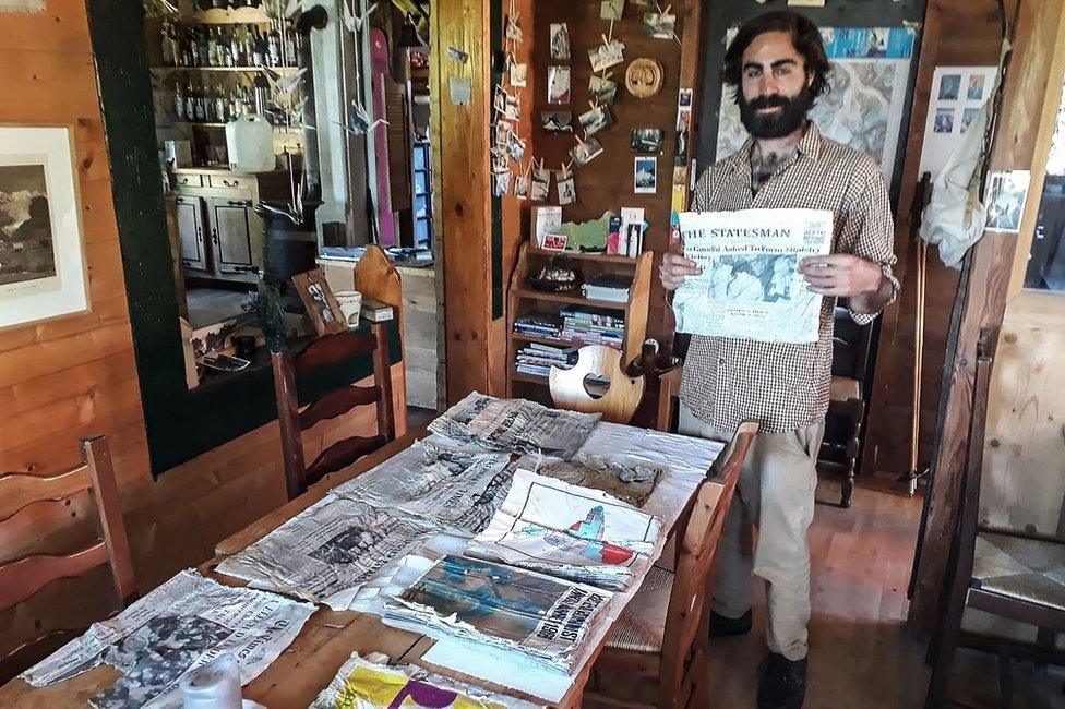 Timothee Mottin with the trove of newspapers