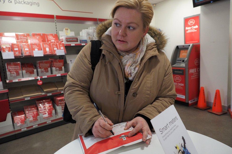 Anna Maria stands in the post office