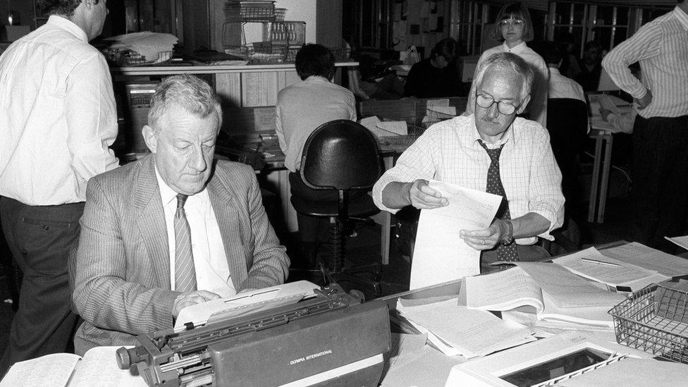 Mr Moncrieff at a typewriter, surrounded by PA staff